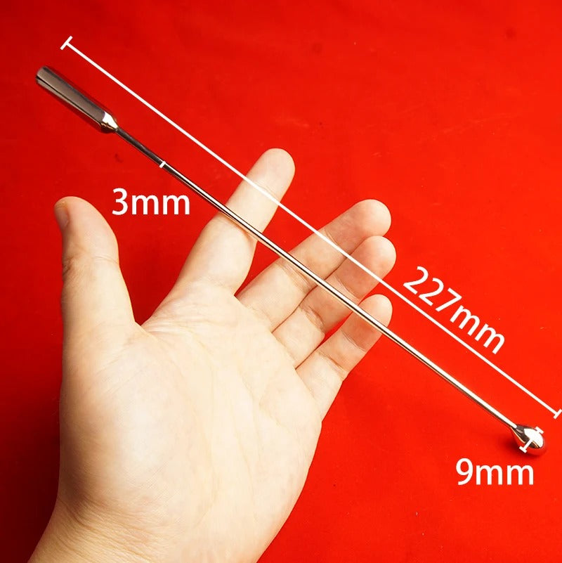 Minimal background shot of stainless steel bullet-tip urethral sound for men, smooth rod-style dilator