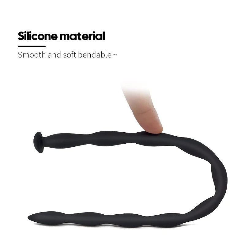 Demonstration of a highly flexible black silicone wave urethral sound being bent easily to show material softness