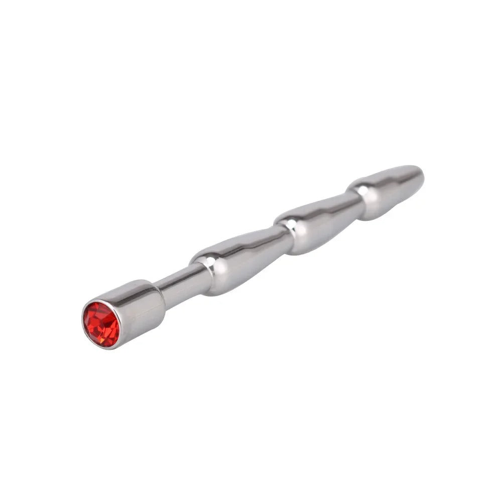 Close-up of pink jewel-style cap on stainless steel urethral plug for men, reflective finish detail