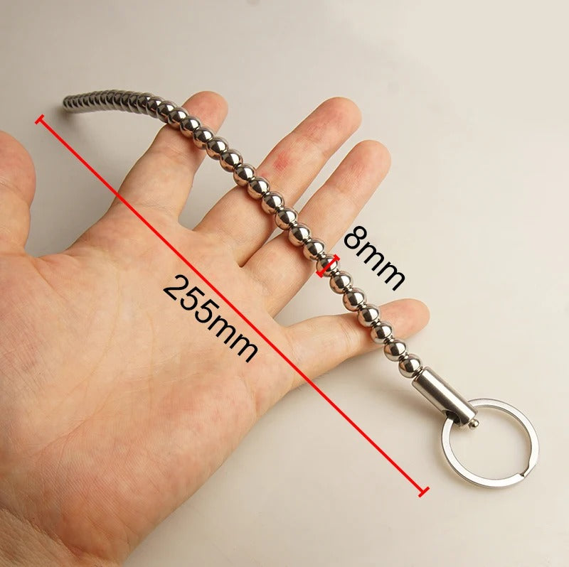 Minimal product shot of stainless steel male urethral beads dilator on clean background